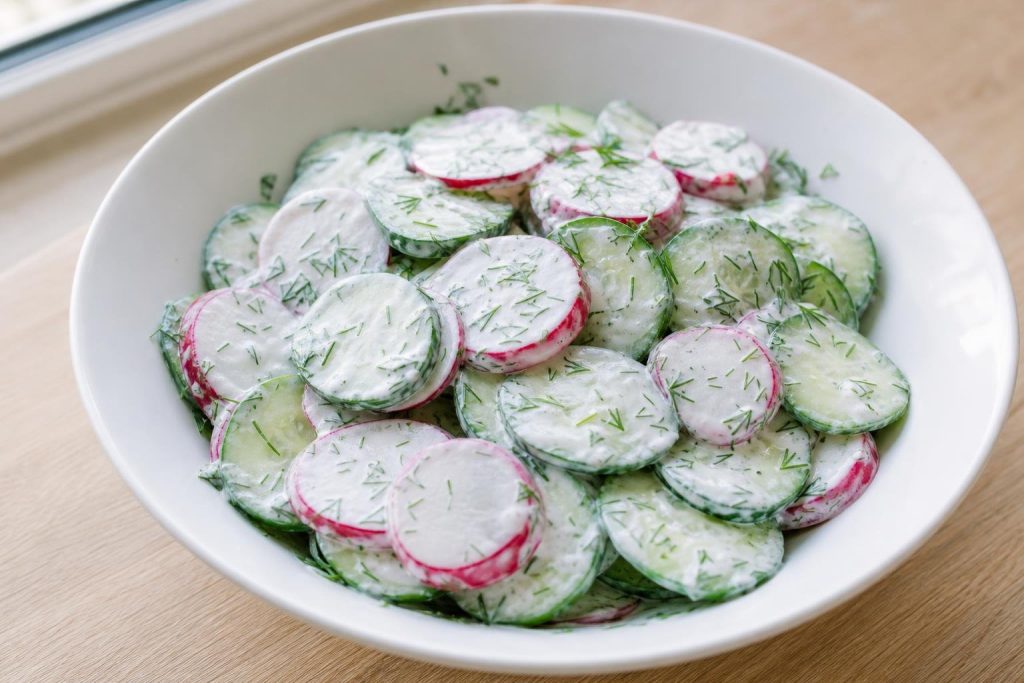 Bowl of cucumber, radish, and dill salad with creamy Greek yogurt dressing
