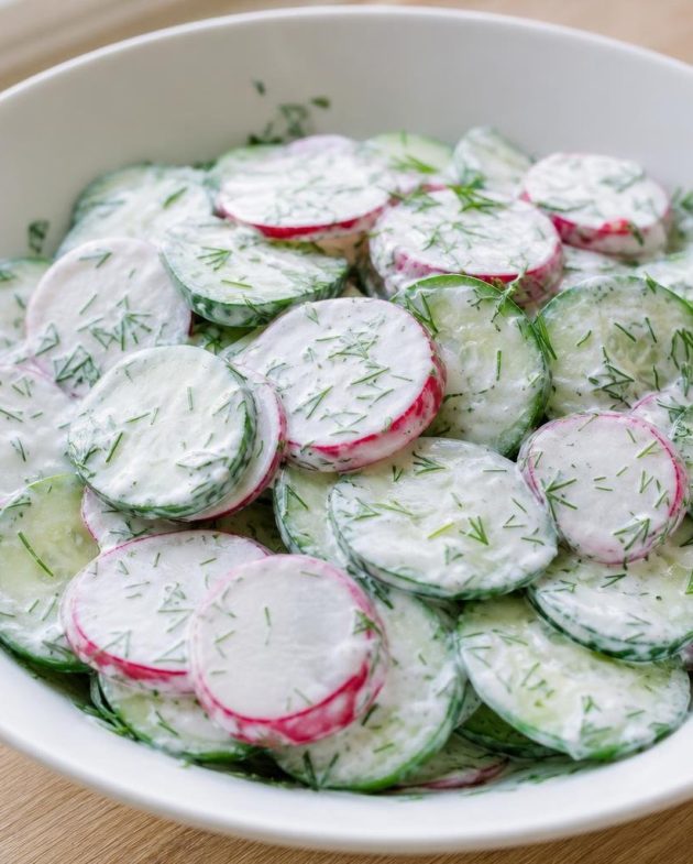 Bowl of cucumber, radish, and dill salad with creamy Greek yogurt dressing