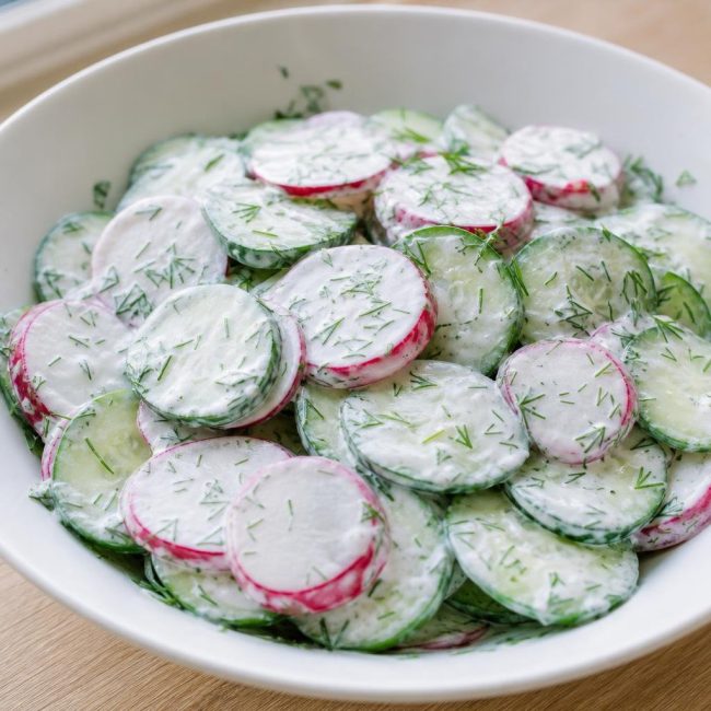 Bowl of cucumber, radish, and dill salad with creamy Greek yogurt dressing