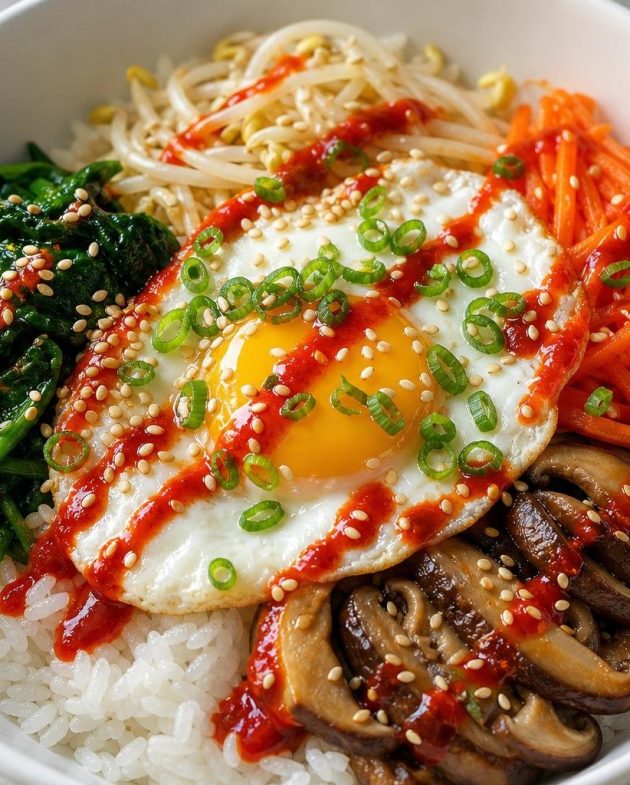 Colorful Korean bibimbap bowl with vegetables, fried egg, and spicy gochujang sauce