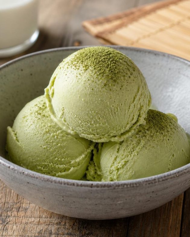 Creamy Japanese matcha green tea ice cream served in a white bowl with matcha powder garnish